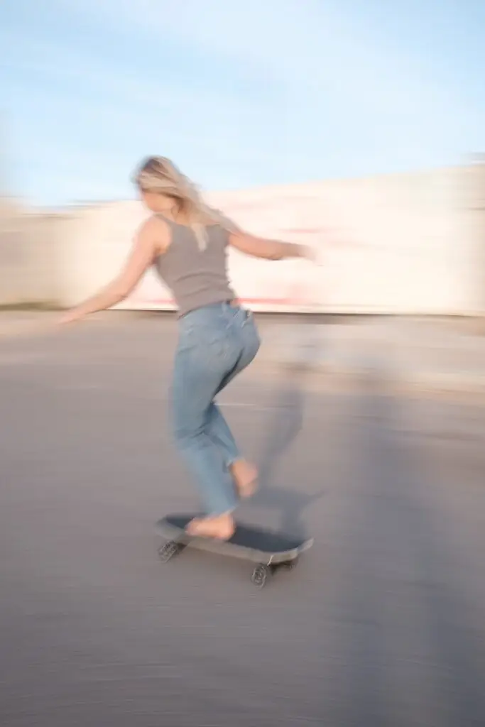 Girl surf-skating in Imsouane. Blurry photo from longer exposure showing the movement